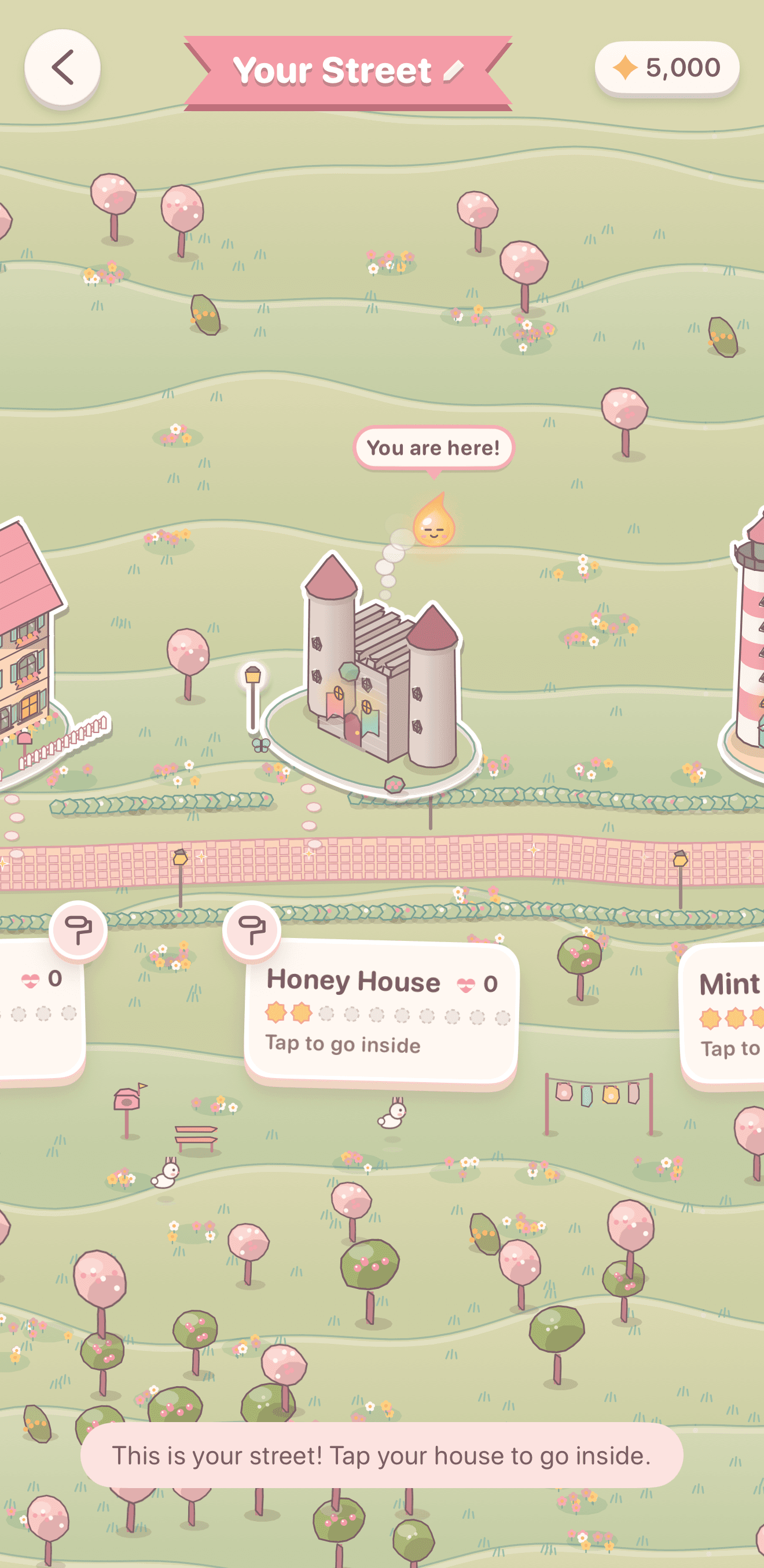 Your Street: the player's own houses in a row among cherry trees, a little castle in the middle with Lumi above it.